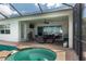 Outdoor patio featuring a hot tub, comfortable seating, a grill, and scenic water views at 5040 Lake Overlook Ave, Bradenton, FL 34208