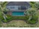 Aerial shot displaying the private screened-in pool, spa, and lush landscaping at 5040 Lake Overlook Ave, Bradenton, FL 34208