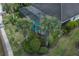 Bird's-eye view captures the screened-in pool area with tropical landscaping for an inviting backyard oasis at 5040 Lake Overlook Ave, Bradenton, FL 34208