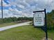 Community canoe/kayak launch entrance sign with gravel path surrounded by lush vegetation at 5040 Lake Overlook Ave, Bradenton, FL 34208