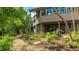 Beautiful backyard with lush landscaping, a relaxing hammock, and a charming covered patio at 5135 Riverwood Ave, Sarasota, FL 34231