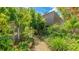 Backyard garden featuring a stone path, lush landscaping, leading to the home's exterior at 5135 Riverwood Ave, Sarasota, FL 34231