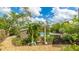 Landscaped backyard featuring garden decor, lush plantings, and an arbor leading to the spa and pool at 5135 Riverwood Ave, Sarasota, FL 34231