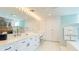 Light-filled bathroom features a double sink vanity, a makeup counter, and sleek white cabinets at 5135 Riverwood Ave, Sarasota, FL 34231