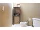 Neutral-toned bathroom with cabinet and toilet at 5135 Riverwood Ave, Sarasota, FL 34231