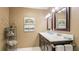 Bathroom featuring double sinks, a dark wood vanity, and a stylish decor at 5135 Riverwood Ave, Sarasota, FL 34231