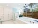 Bright bathroom featuring a garden bath under a greenhouse-style window at 5135 Riverwood Ave, Sarasota, FL 34231