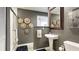 Elegant bathroom featuring a pedestal sink, walk-in shower, and tasteful decor at 5135 Riverwood Ave, Sarasota, FL 34231