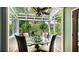 This breakfast nook features a glass roof and glass window walls offering an unobstructed view of the outdoors at 5135 Riverwood Ave, Sarasota, FL 34231