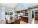Formal dining room with built-in cabinets, large windows, and stylish chandelier at 5135 Riverwood Ave, Sarasota, FL 34231