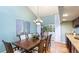 Bright dining room featuring large windows, a chandelier, and seating for eight at 5135 Riverwood Ave, Sarasota, FL 34231
