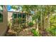 Landscaped side yard with a pea gravel path leading around the property, creating a tranquil outdoor space at 5135 Riverwood Ave, Sarasota, FL 34231
