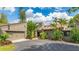 A contemporary home exterior with a private driveway and attached garage at 5135 Riverwood Ave, Sarasota, FL 34231