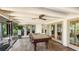 The game room features terracotta tile flooring, a beamed ceiling, and a billiard table for added entertainment at 5135 Riverwood Ave, Sarasota, FL 34231
