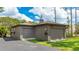 Detached two-car garage with an asphalt driveway, well-maintained landscaping, and a charming cupola at 5135 Riverwood Ave, Sarasota, FL 34231