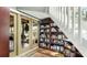 Hallway features french doors to the exterior, a bookcase, and a unique spiral staircase at 5135 Riverwood Ave, Sarasota, FL 34231