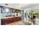 This kitchen features a wet bar with cabinets, tile floors, and an adjacent breakfast nook overlooking the exterior at 5135 Riverwood Ave, Sarasota, FL 34231