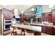 Bright kitchen features custom cabinetry, a large granite countertop, and stainless steel appliances at 5135 Riverwood Ave, Sarasota, FL 34231