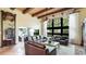 Bright living room with wood beamed ceiling, seating area, and large windows at 5135 Riverwood Ave, Sarasota, FL 34231