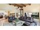 Spacious living room with high ceilings, exposed beams, fireplace, and comfortable leather seating at 5135 Riverwood Ave, Sarasota, FL 34231