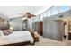 This is the main bedroom with a ceiling fan, carpet floors, and multiple windows with wooded views at 5135 Riverwood Ave, Sarasota, FL 34231