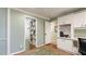 Another angle of bright office featuring built-in cabinets and shelving with cozy rug at 5135 Riverwood Ave, Sarasota, FL 34231