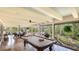 Spacious screened patio with a pool table and outdoor lounge area at 5135 Riverwood Ave, Sarasota, FL 34231