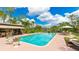 Large, inviting swimming pool surrounded by a brick patio and lush landscaping, perfect for outdoor entertaining at 5135 Riverwood Ave, Sarasota, FL 34231