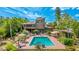 An aerial view of a luxury backyard, swimming pool, and patio with outdoor seating at 5135 Riverwood Ave, Sarasota, FL 34231