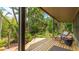 Relaxing outdoor porch with wooden flooring and comfortable rocking chair overlooking a lush yard at 5135 Riverwood Ave, Sarasota, FL 34231