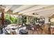 This sun room provides a relaxing space with comfortable seating and views of the landscaped yard at 5135 Riverwood Ave, Sarasota, FL 34231