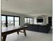 Spacious living area with pool table, comfortable seating, and sliding glass doors to outdoor space at 5174 Conner Ter, Port Charlotte, FL 33981