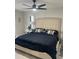 Relaxing main bedroom with neutral tones, a ceiling fan, and mirrored bedside tables at 5174 Conner Ter, Port Charlotte, FL 33981