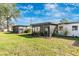 Well-maintained backyard featuring a screened patio, lush green grass, and serene surroundings at 6124 Green View Dr # 139, Sarasota, FL 34231