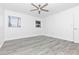 This bedroom has wood-look floors, a ceiling fan, and two windows for ample natural light at 6124 Green View Dr # 139, Sarasota, FL 34231