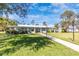 Well manicured lawn and sidewalk lead to the entrance of the clubhouse with lots of light at 6124 Green View Dr # 139, Sarasota, FL 34231