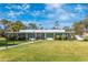 A well-manicured lawn leads to the Clubhouse entrance, flanked by professional landscaping at 6124 Green View Dr # 139, Sarasota, FL 34231