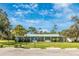Clubhouse exterior featuring professional landscaping, an accessible entrance, and ample parking at 6124 Green View Dr # 139, Sarasota, FL 34231