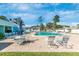 Sparkling community pool area featuring lounge chairs, shaded tables, and plenty of space to relax at 6124 Green View Dr # 139, Sarasota, FL 34231