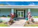 A professionally landscaped entrance with turquoise planters leads into the community clubhouse at 6124 Green View Dr # 139, Sarasota, FL 34231