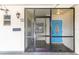 Enclosed front porch with security doors and bright blue front door at 6124 Green View Dr # 139, Sarasota, FL 34231