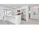 Modern kitchen with stainless steel appliances, white cabinetry, and a large island with quartz countertops at 6124 Green View Dr # 139, Sarasota, FL 34231
