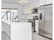 This newly remodeled kitchen has white cabinets, stainless steel appliances, and laminate flooring at 6124 Green View Dr # 139, Sarasota, FL 34231