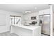 Contemporary kitchen with stainless steel appliances, sleek white cabinets, and a quartz countertop island at 6124 Green View Dr # 139, Sarasota, FL 34231