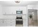 Updated kitchen featuring stainless steel appliances, white cabinets, and modern countertops at 6124 Green View Dr # 139, Sarasota, FL 34231
