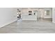 Open floor plan featuring updated kitchen, stainless appliances, and hardwood style floors at 6124 Green View Dr # 139, Sarasota, FL 34231