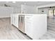 Open kitchen with island, stainless steel dishwasher, white cabinets and quartz countertops, open to living areas at 6124 Green View Dr # 139, Sarasota, FL 34231