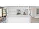 Bright, modern kitchen with quartz countertops, stainless appliances, and access to the screened lanai at 6124 Green View Dr # 139, Sarasota, FL 34231