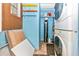Functional laundry room with stackable washer/dryer and colorful storage shelves at 6124 Green View Dr # 139, Sarasota, FL 34231