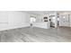 Open-concept living area featuring wood-look floors, modern kitchen with stainless steel appliances and breakfast bar at 6124 Green View Dr # 139, Sarasota, FL 34231